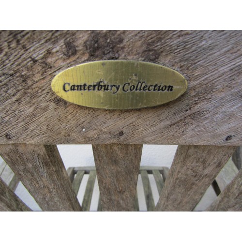 276 - A Canterbury Collection weathered teak circular folding gateleg garden table and four matching armch... 