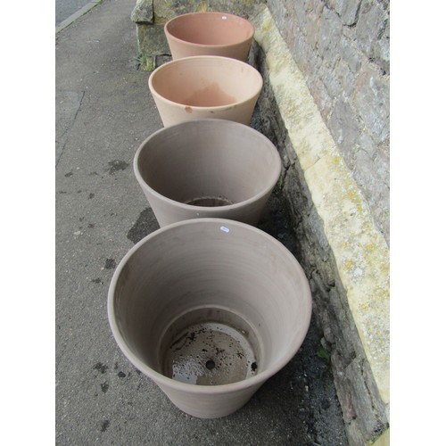 208 - Eight contemporary terracotta planters of circular form (two sizes) the largest 45cm high x 50cm dia... 