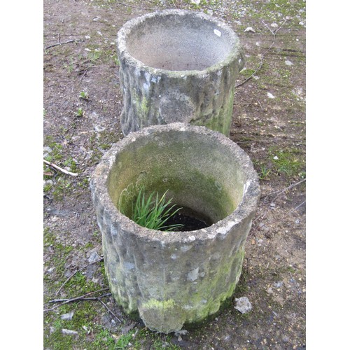 197 - A pair of weathered cast composition stone garden planters in the form of tree stumps, 29cm high, 30... 