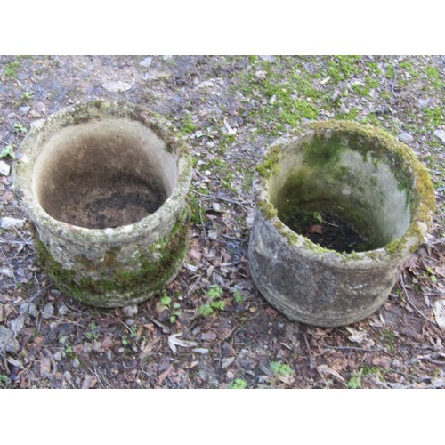 198 - A pair of weathered cast composition stone squat cylindrical planters with repeating classical winge... 