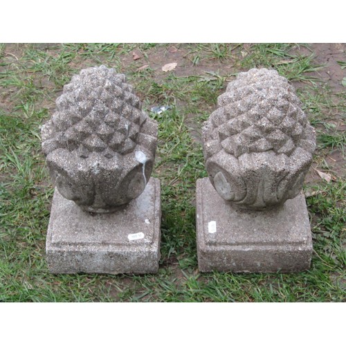 263 - A pair of small weathered cast composition stone pier caps with pineapple finials, 32cm high x 18cm ... 