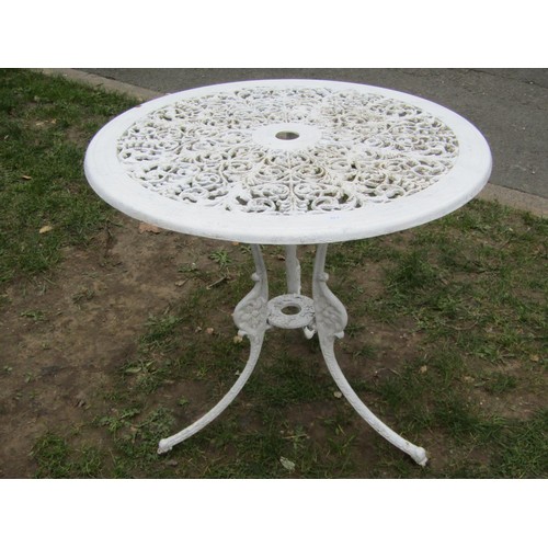 272 - A cream painted cast aluminium garden table of circular form with decorative pierced scrolling folia... 