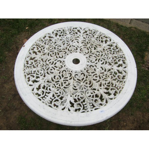 272 - A cream painted cast aluminium garden table of circular form with decorative pierced scrolling folia... 