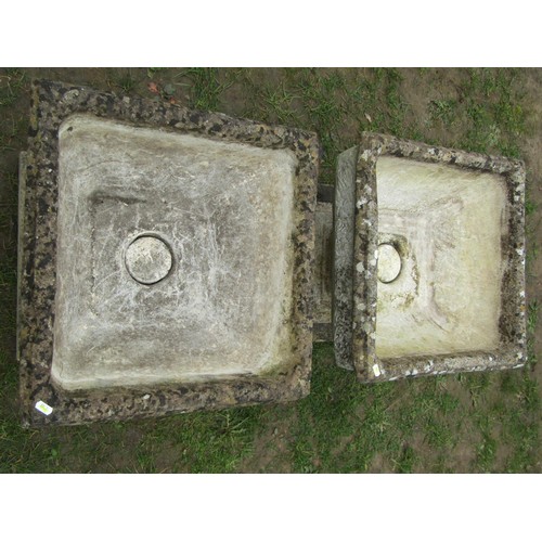 275 - A pair of weathered cast composition stone garden urns of squat square cut and tapered form with ros... 