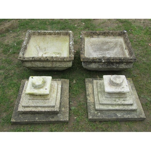 275 - A pair of weathered cast composition stone garden urns of squat square cut and tapered form with ros... 