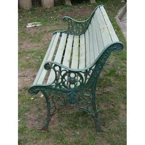 279 - A two seat garden bench with painted wooden slatted seat raised on decorative pierced cast iron end ... 