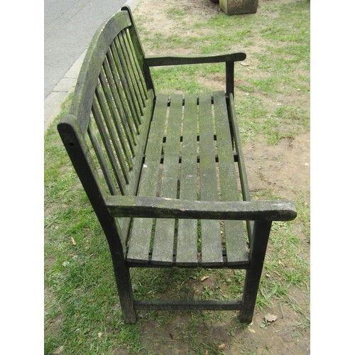 280 - A weathered teak two seat garden bench with slatted seat and back beneath an arched rail 122 cm wide... 