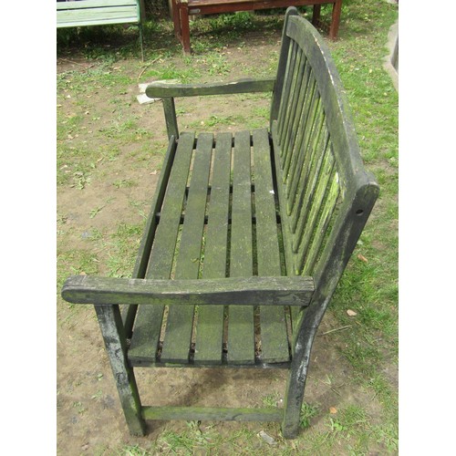 280 - A weathered teak two seat garden bench with slatted seat and back beneath an arched rail 122 cm wide... 