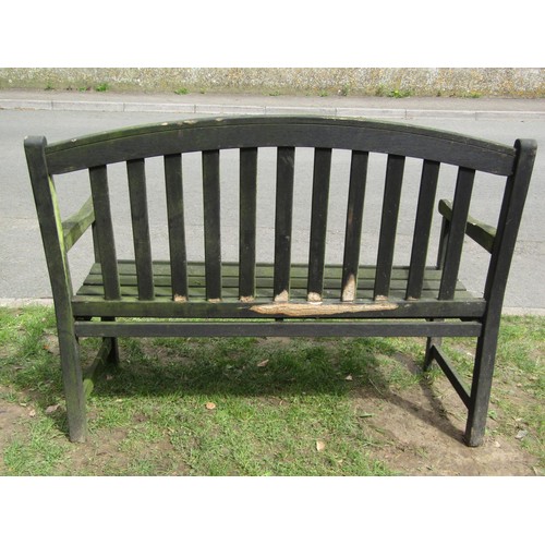 280 - A weathered teak two seat garden bench with slatted seat and back beneath an arched rail 122 cm wide... 