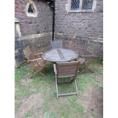 297 - A weathered contemporary Teak folding garden table and four chairs