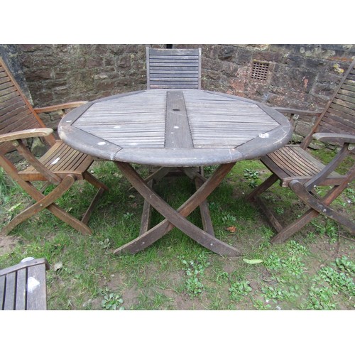 297 - A weathered contemporary Teak folding garden table and four chairs