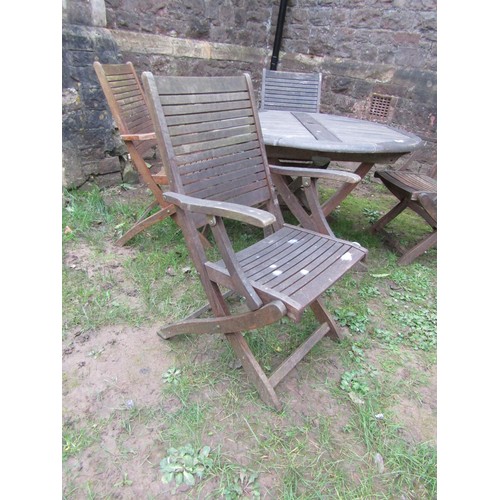 297 - A weathered contemporary Teak folding garden table and four chairs