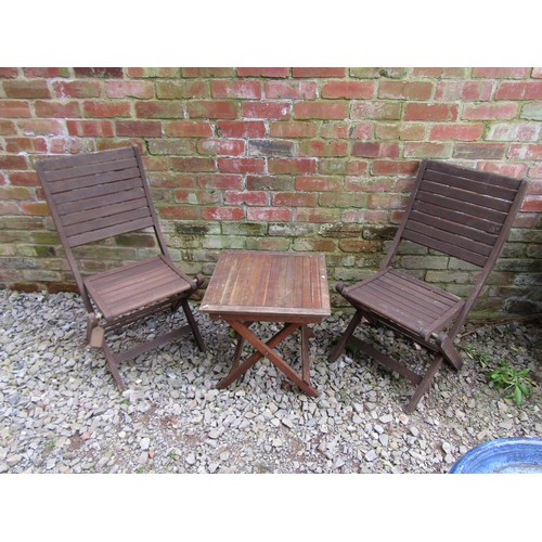 251 - A weathered stained hardwood three piece folding terrace set with slatted detail, the table 50 cm sq... 