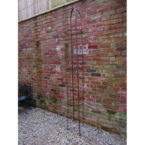 260 - A weathered steel strapwork garden obelisk of cylindrical form with domed top, 260cm high