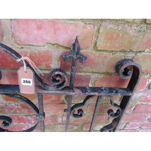 266 - A heavy gauge iron gate with decorative open scroll work detail and spearhead finials, 121cm high x ... 