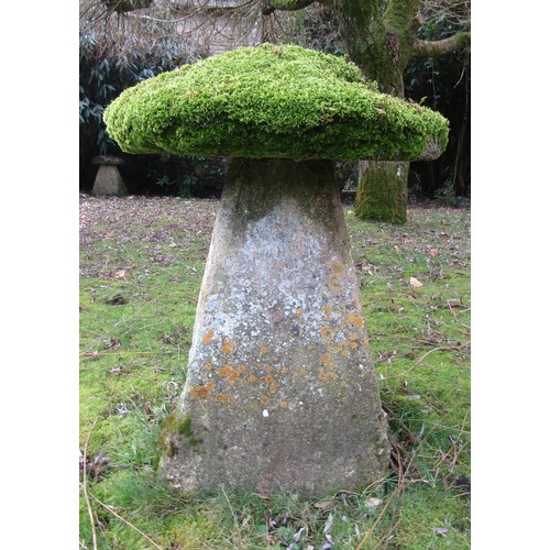 A substantial limestone staddle stone and cap heavily moss encrusted, 80 cm height