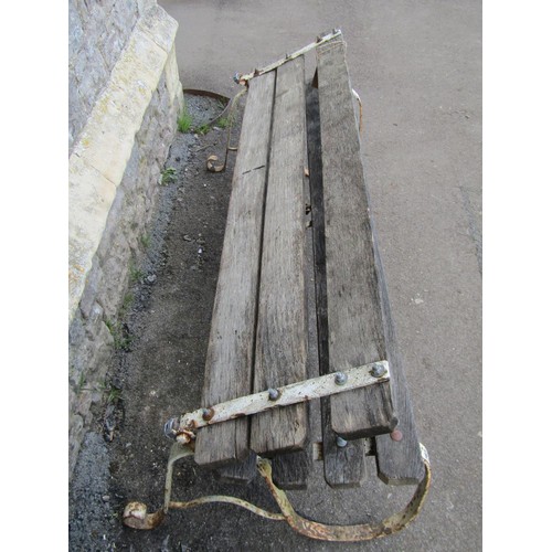 284 - An old unusual garden bench with weathered timber slatted seat and back (able to fold) raised on pai... 