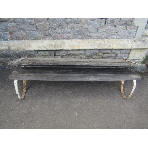 284 - An old unusual garden bench with weathered timber slatted seat and back (able to fold) raised on pai... 