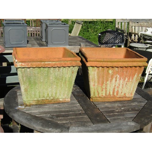 73 - A pair of weathered terracotta square tapered and reeded planters, 30 cm high x 38 cm square approxi... 