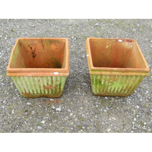 73 - A pair of weathered terracotta square tapered and reeded planters, 30 cm high x 38 cm square approxi... 