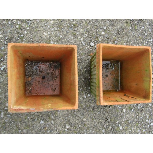 73 - A pair of weathered terracotta square tapered and reeded planters, 30 cm high x 38 cm square approxi... 