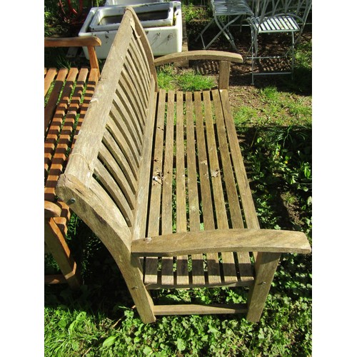 154 - A weathered ‘Canterbury Collection’ teak garden bench with curved slatted seat, back and arms (AF) 1... 