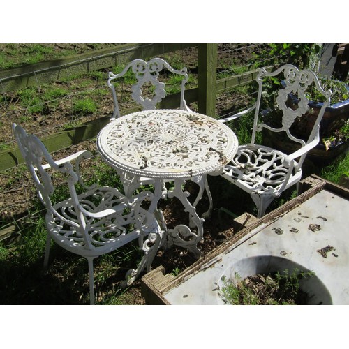 168 - A small weathered cast iron terrace table with decorative pierced circular top raised on scrolled su... 