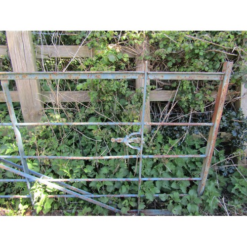 174 - An old painted and weathered heavy iron gate, with horizontal open bars and simple scroll detail (po... 