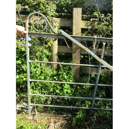 174 - An old painted and weathered heavy iron gate, with horizontal open bars and simple scroll detail (po... 