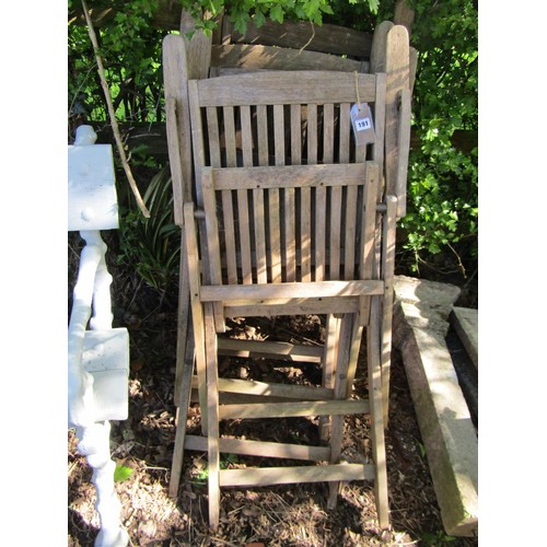 191 - A set of four weathered teak folding garden armchairs with slender slatted seats and backs (af)