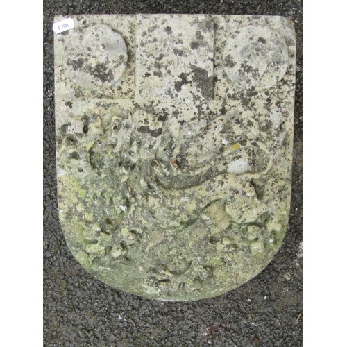 512 - An antique weathered carved stone armorial  shield shaped boss with rampant lion detail, 37 cm x 29 ... 