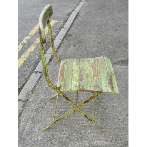 526 - A small rustic painted iron-framed folding patio chair, with green-painted finish