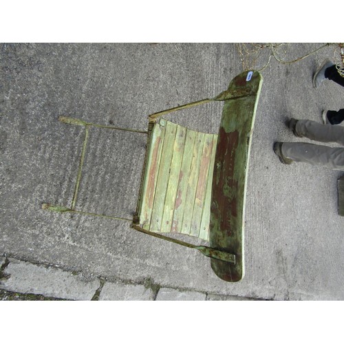 526 - A small rustic painted iron-framed folding patio chair, with green-painted finish