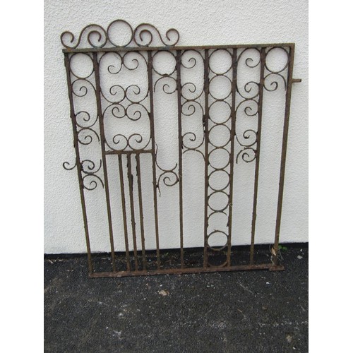 526A - An old weathered ironwork garden gate with scrolling detail, 104cm high, 96cm wide