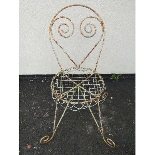 542 - A pair of weathered painted garden / patio chairs, with scrolling framework and wire work seats (2)