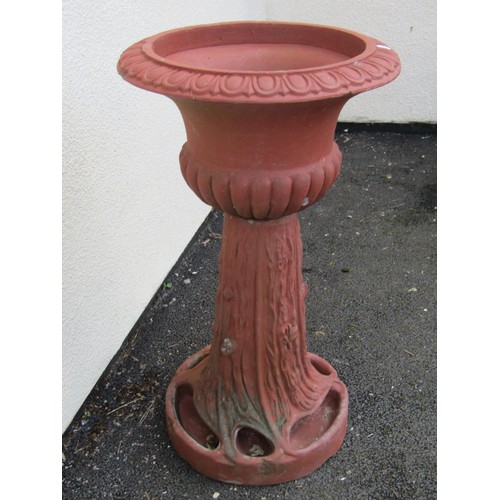 545 - A large moulded terracotta planter jardiniere / planter on stand, the urn with flared egg and dart r... 