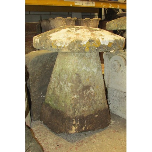 507 - A weathered carved natural stone staddle stone and associated cap, 70cm high, 60cm diameter.