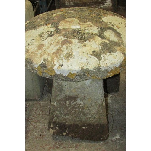 507 - A weathered carved natural stone staddle stone and associated cap, 70cm high, 60cm diameter.