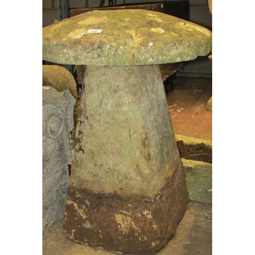 508 - A weathered carved natural limestone staddle stone and associated cap, 75cm high, 60cm diameter.