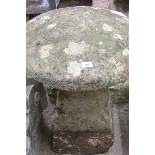 508 - A weathered carved natural limestone staddle stone and associated cap, 75cm high, 60cm diameter.