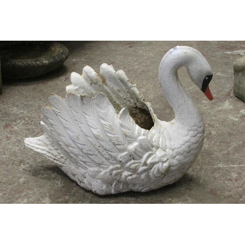 519 - A heavy antique cast iron planter in the form of a swan with painted finish, 38cm high, 45cm wide