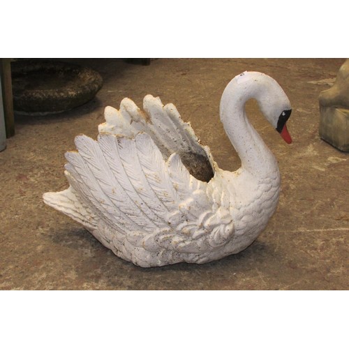 519 - A heavy antique cast iron planter in the form of a swan with painted finish, 38cm high, 45cm wide