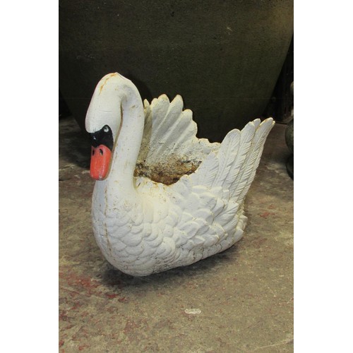 519 - A heavy antique cast iron planter in the form of a swan with painted finish, 38cm high, 45cm wide