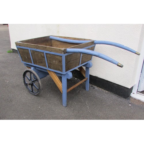 529 - A wooden hand cart/barrow with partially painted frame and shafts, two cast iron spoke wheels, with ... 