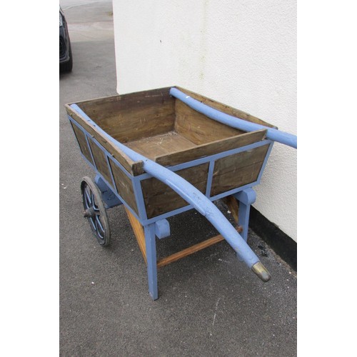 529 - A wooden hand cart/barrow with partially painted frame and shafts, two cast iron spoke wheels, with ... 