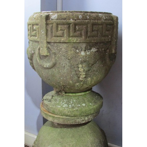 533 - A matched set of four weathered composition stone planters, of pedestal urn form with moulded Greek ... 