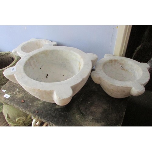 534 - Three graduating old carved white marble mortars, the largest 22cm high, 48cm diameter (maximum)