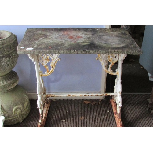 535 - A Victorian cast iron tavern table, the scrolling trestle framework with white painted finish, below... 