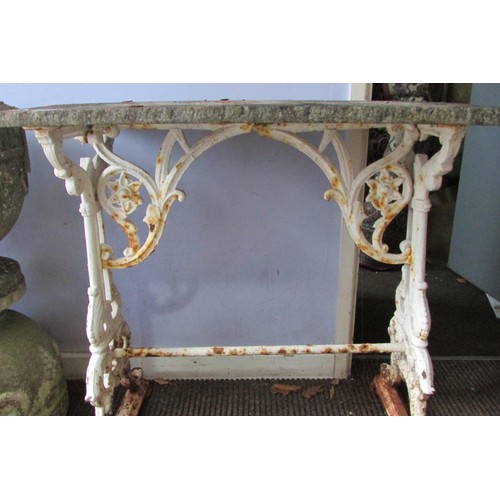 535 - A Victorian cast iron tavern table, the scrolling trestle framework with white painted finish, below... 