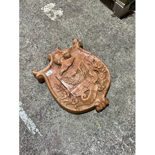 552 - A decorative continental carved red marble armorial shield, 46 x 36cm